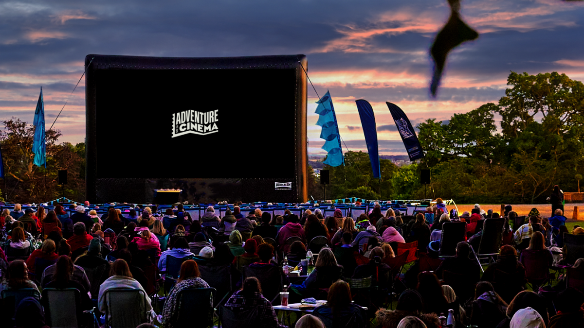 Adventure Cinema logo at a spooky outdoor cinema