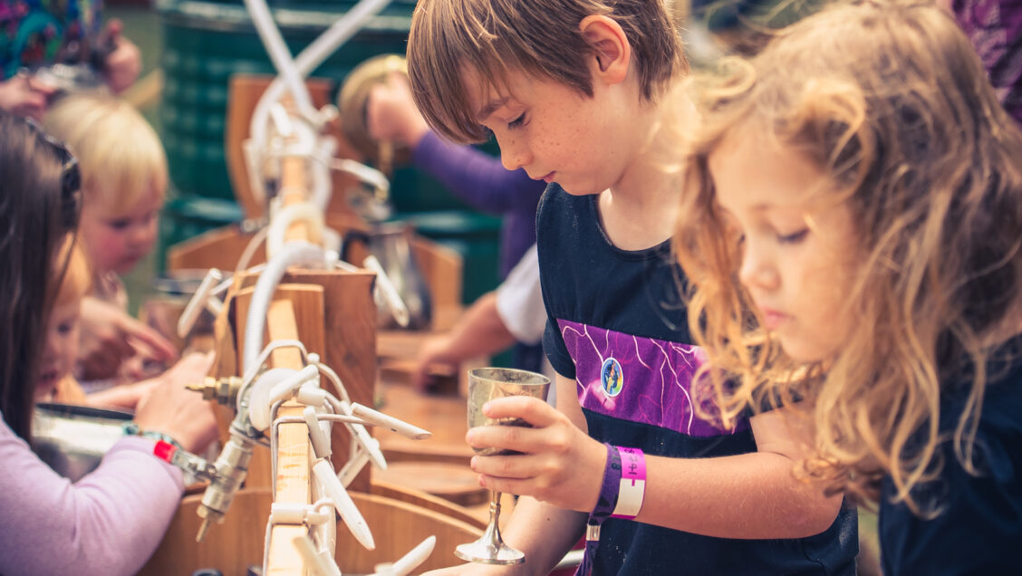 Children building things on a long table